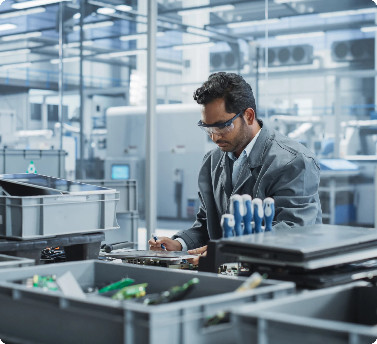 Technician working at electronics manufacturing facility.